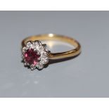An 18ct, ruby and diamond cluster ring, size N.