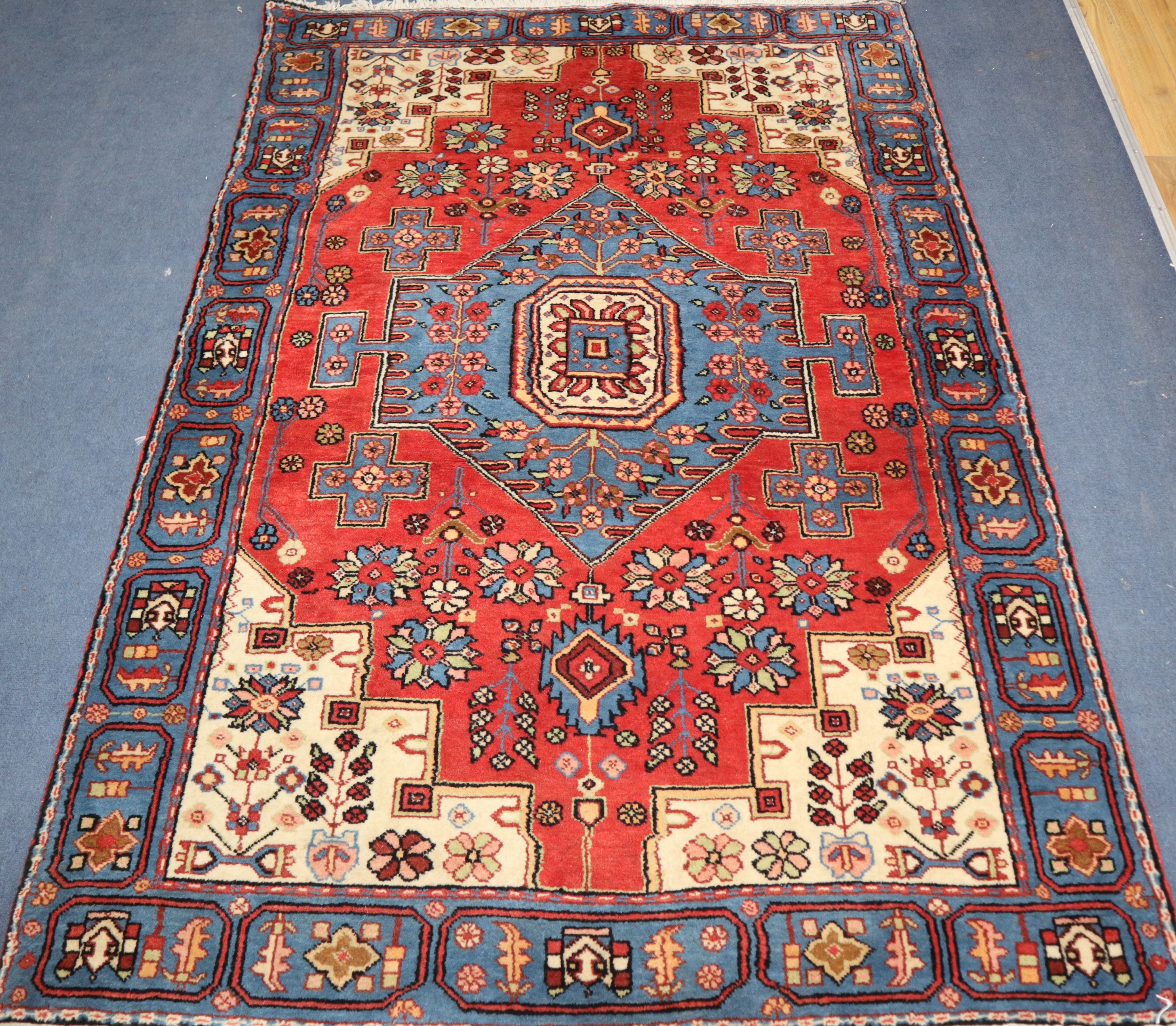 A Persian red ground rug 207 x 134cm