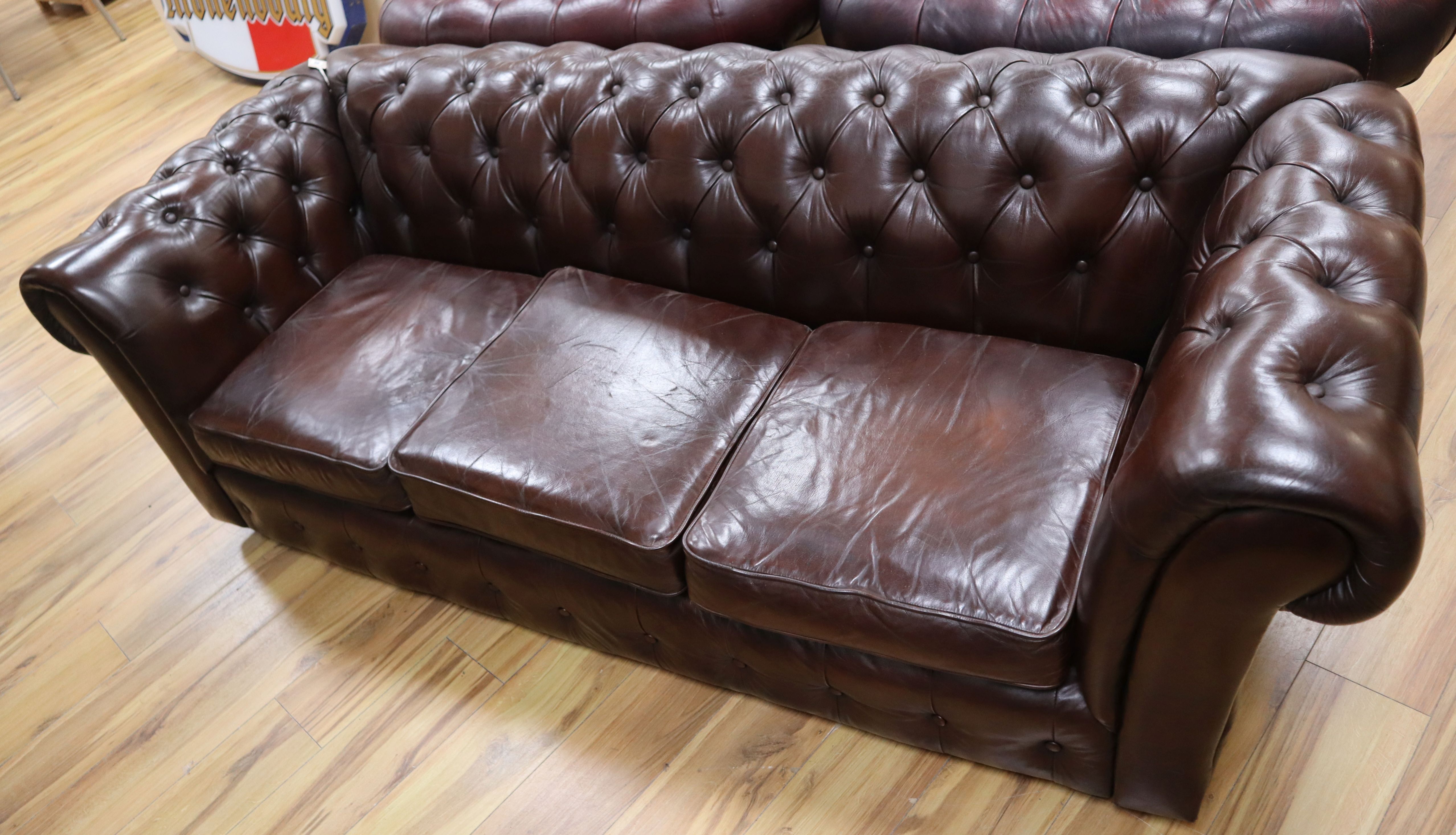 A three seater bown leather Chesterfield settee W.200cm