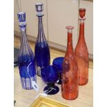 Two blue overlay glass decanters and stoppers, two ruby flask glass decanters and a pair of blue