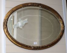 A 19th century oval giltwood and gesso wall mirror W.91cm