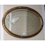 A 19th century oval giltwood and gesso wall mirror W.91cm