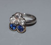 A yellow and white(stamped platinum) metal, sapphire and dianond set clusater ring, size F.