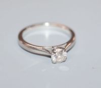 A modern 18ct white gold and solitaire diamond ring, the stone measuring 4.8mm. size K.