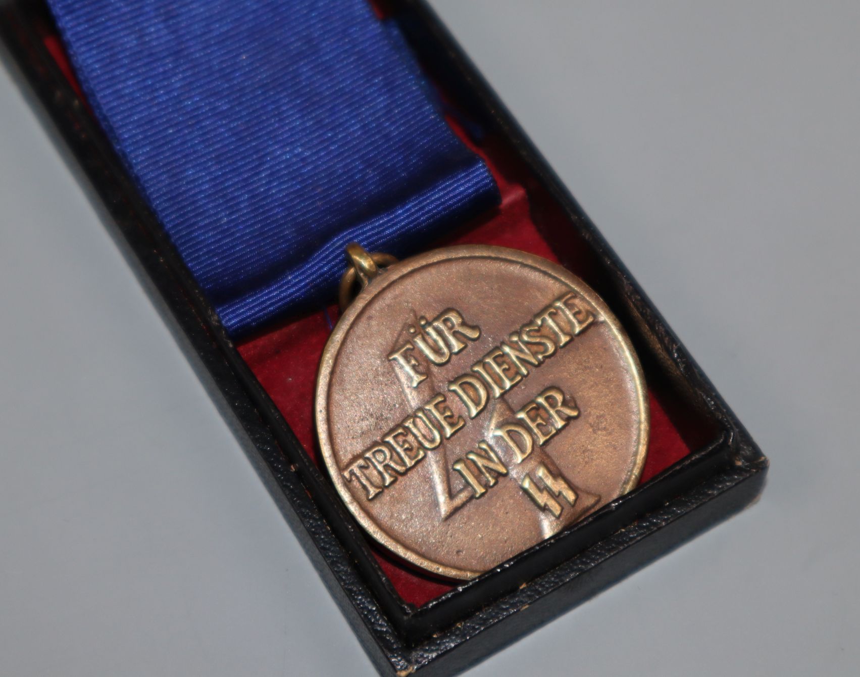 A boxed SS 4 Year medal