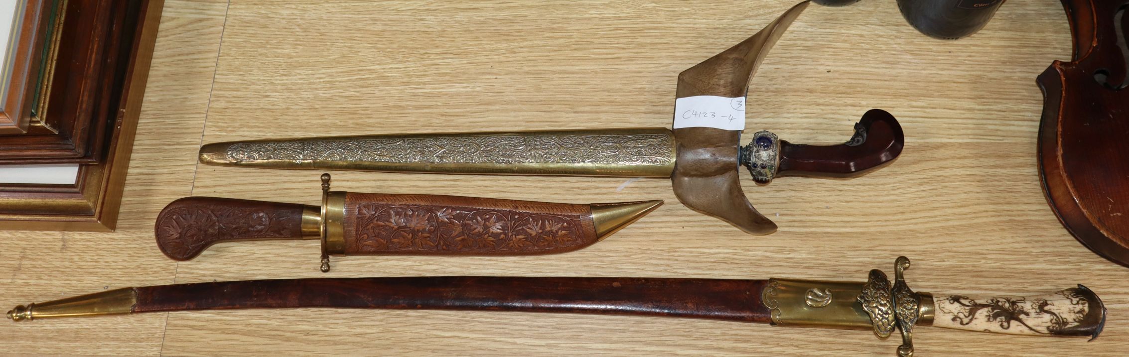 An 18th century and later hunting hanger, a 19th century Kris and an Indian dagger