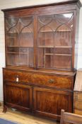 A 19th century mahogany bookcase, the upper section enclosed by a pair of astragal-glazed doors W.