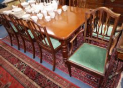 A Victorian style mahogany extending dining table and a set of eight Edwardian inlaid mahogany