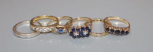 Six assorted gem set rings, including two 18ct and diamond half hoop, 18ct sapphire and diamond, two