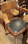 An early 20th century beech swivel desk chair