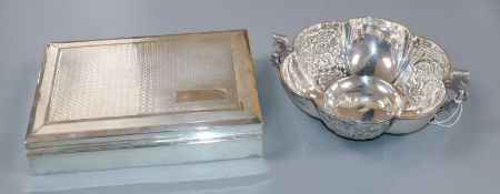 An Edwardian silver two handled lobed bowl, Chester, 1905 and a 1930's silver cigarette box.