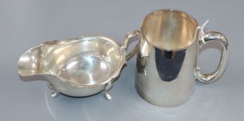 A 1950's silver mug by Adie Brothers and a 1930's silver sauceboat, 13 oz.