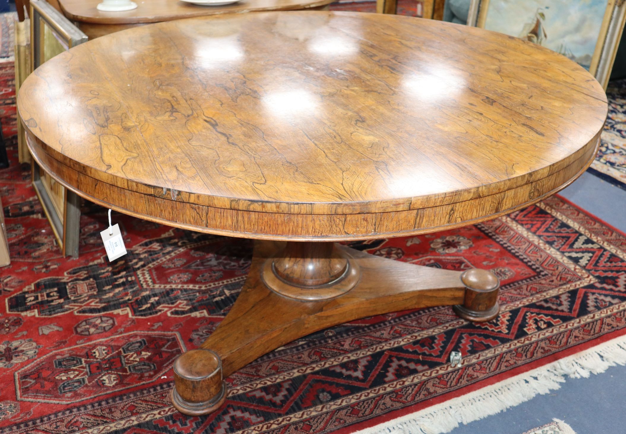 A Victorian rosewood circular tilt top breakfast table with later faux marble top Diameter 135cm