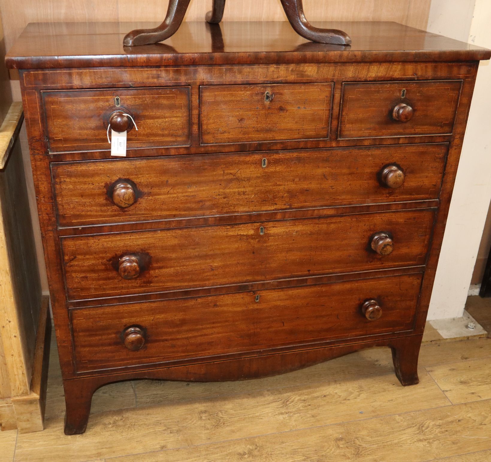 A George IV inlaid mahogany chest of drawers with a secretaire drawer W.120cm