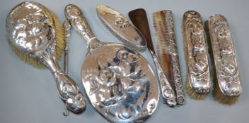 An early 20th century seven piece silver mirror and brush set by William Comyns, London, 1906/7/9