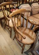 A pair of early 20th century elm comb back elbow chairs