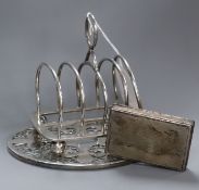 An Edwardian silver toastrack, by Elkington & Co, Birmingham, 1907, a silver overlaid glass teapot