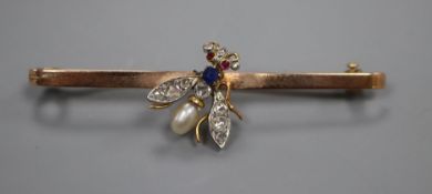 An early 20th century 9ct, diamond, sapphire, baroque pearl and ruby set 'fly' bar brooch, 59mm.