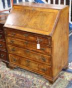 A George III style figured walnut bureau W.84cm