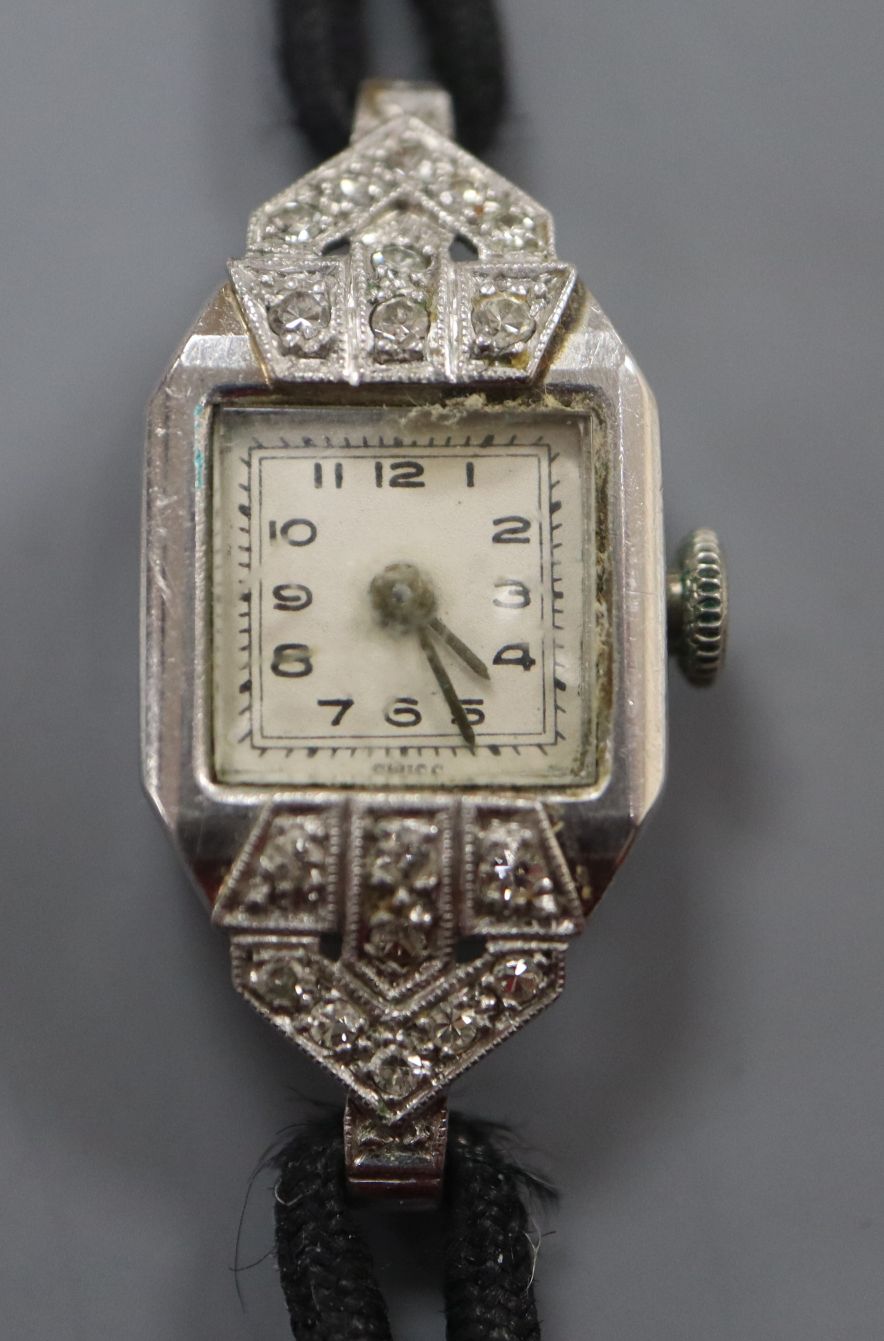 A lady's white metal (stamped platinum) and diamond set cocktail watch, on fabric strap.