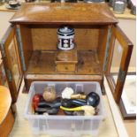 A group of Victorian and later meerschaum and clay pipes with an Edwardian oak smoker's cabinet