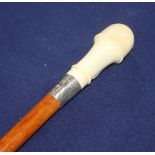 A maple walking cane with white metal collar, ivory handle and miniature domino compartment