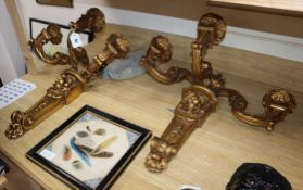 A pair of three branch gilt lion decorated sconces height 56cm