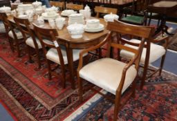 A mahogany extending dining table and a set of eight inlaid mahogany dining chairs (two with arms)