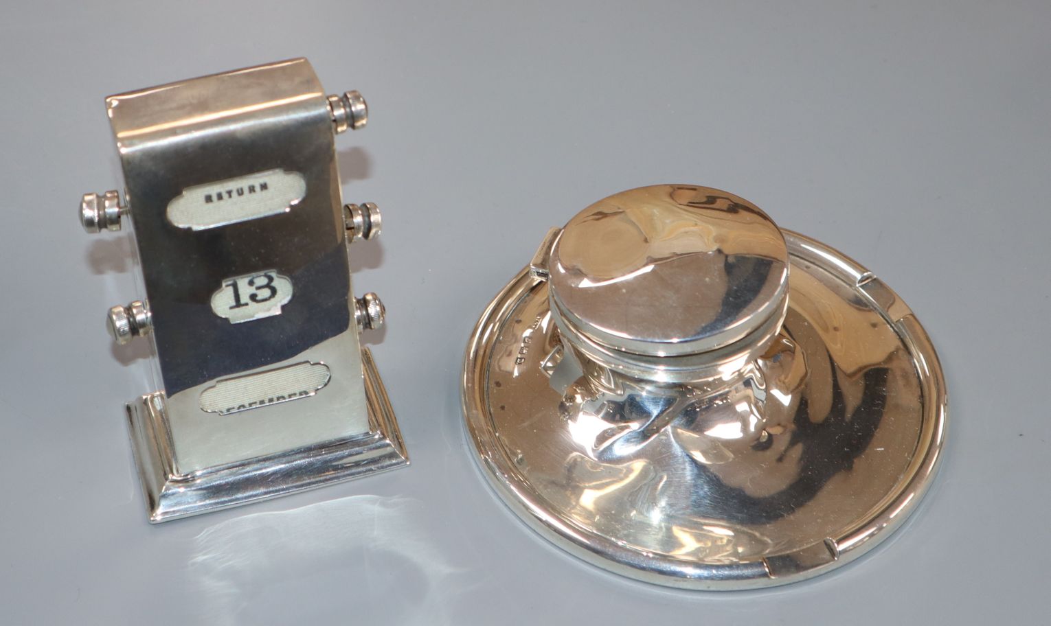 A late 1920's silver inkstand and silver mounted desk calendar.
