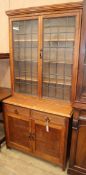 An early 20th century oak bookcase with leaded glass doors W.92cm