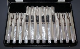 A cased matched set of six pairs of George V mother of pearl handled silver dessert eaters.