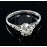 A mid 20th century platinum and single stone diamond ring, with diamond set shoulders, the central