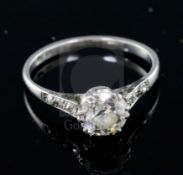 A mid 20th century platinum and single stone diamond ring, with diamond set shoulders, the central