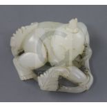 A Chinese white jade figure of a boy, 19th century, crouching and holding a leafy tendril, the stone