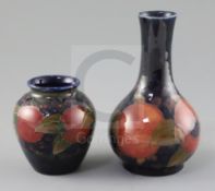 Two Moorcroft 'pomegranate' vases, c.1918-26, the first of ovoid form, the second bottle shaped,