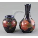 Two Moorcroft 'pomegranate' vases, c.1918-26, the first of ovoid form, the second bottle shaped,