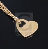 A modern 18ct gold Cartier pierced heart shaped pendant, on an 18ct gold Cartier fine link chain,