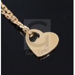 A modern 18ct gold Cartier pierced heart shaped pendant, on an 18ct gold Cartier fine link chain,