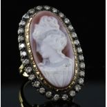 An 18ct gold, sardonyx hardstone cameo and diamond set oval dress ring, the stone carved with the