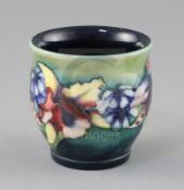 A Moorcroft 'orchid' small vase, 1930's, with a green to blue graduated ground, impressed W.