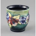 A Moorcroft 'orchid' small vase, 1930's, with a green to blue graduated ground, impressed W.