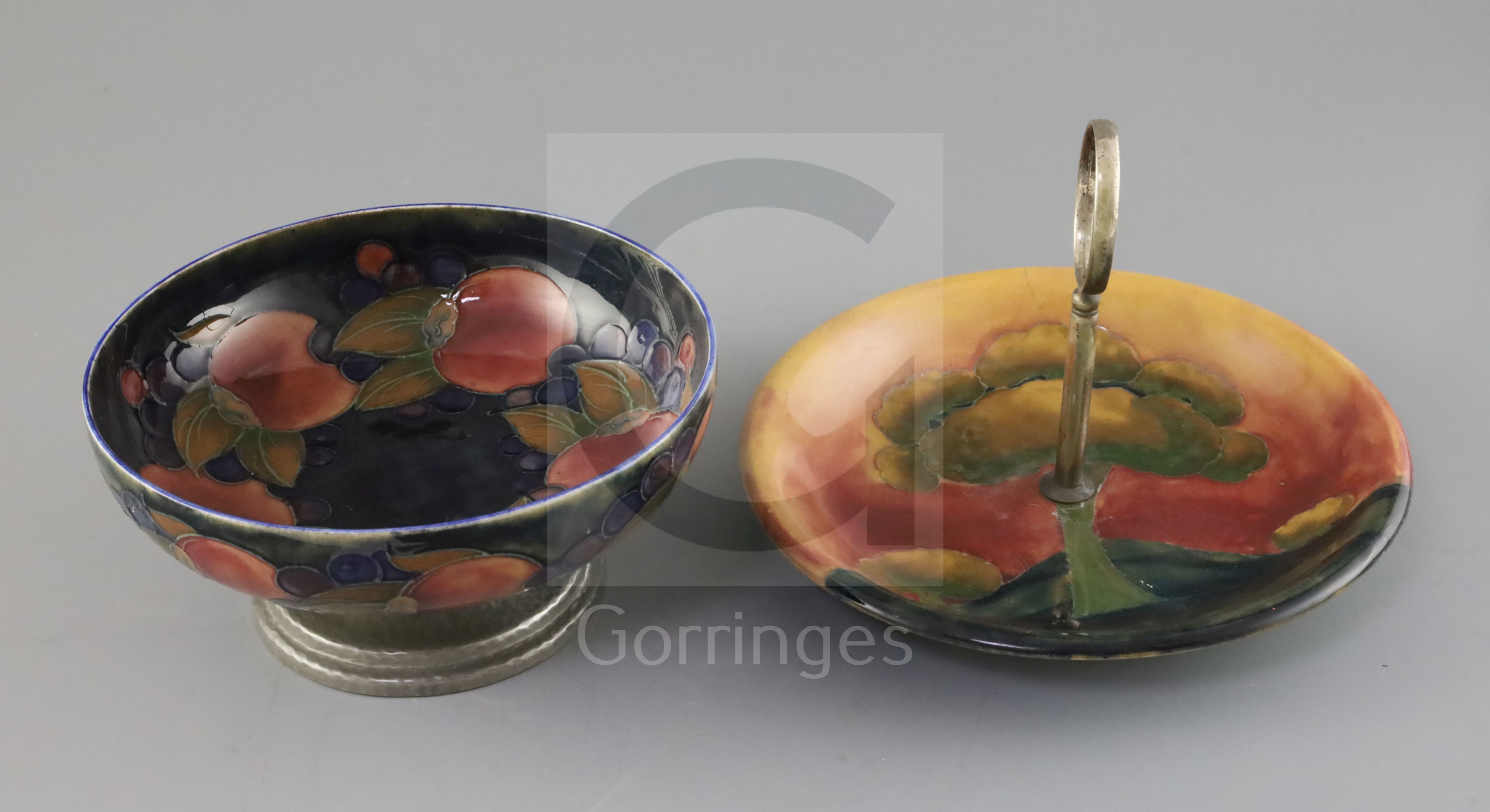 A Moorcroft 'pomegranate' and Tudric pewter mounted bowl and an 'Eventide' cake dish, c.1920-5,