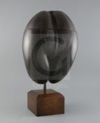 A coco-de-mer nut, with hinged top and hardwood display stand, H.19in.