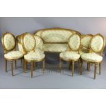 An early 20th century Louis XVI style carved and giltwood seven piece salon suite, comprising a