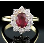 An 18ct yellow gold and platinum, ruby and diamond oval cluster ring, size O/P.