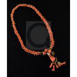 A late 19th/early 20th century gold mounted carved coral choker necklace with clasp set with coral