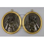 A pair of 19th century French bronze oval relief plaques of Bacchanalian women, in ormolu frames,
