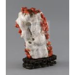 A Chinese chalcedony vase, in imitation of coral, skillfully carved to the contrasting coral red and