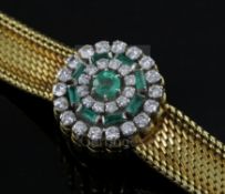 A lady's 18ct gold Jaeger Le Coultre 18ct gold, emerald and diamond set cocktail bracelet watch, the