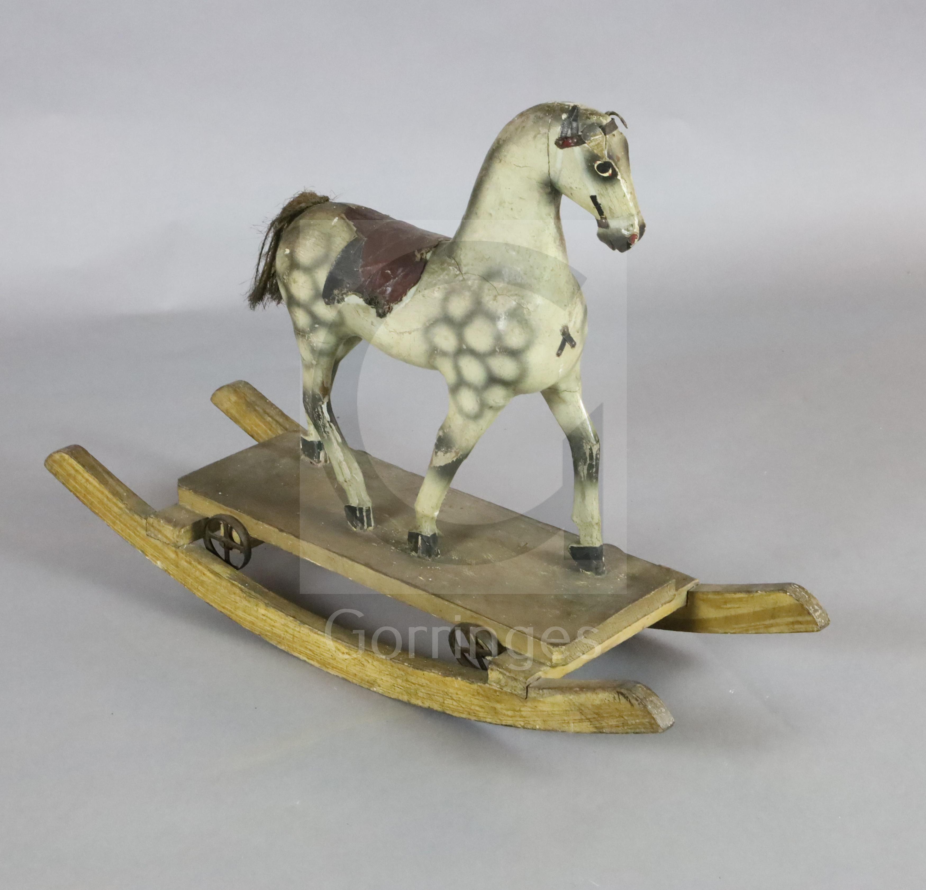 A rare Victorian carved and painted wood dapple grey rocking horse, of small proportions, with